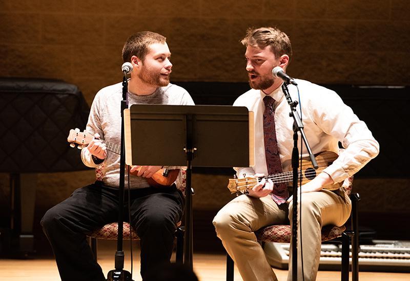 two men playing guitars